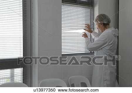 Factory worker peeping through blind View Large Photo Image Stock Image - Factory worker peeping through blind. Fotosearch