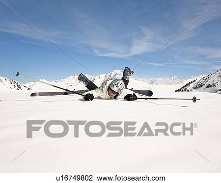 Fallen woman wearing skis, in snow View Large Photo Image Stock Image - Fallen woman wearing skis, in snow. Fotosearch
