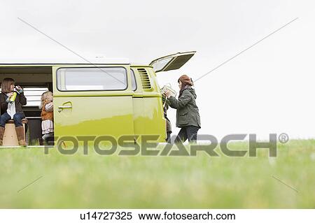 Family and camper van in open field View Large Photo Image Stock Photography - Family and camper van in open field. Fotosearch