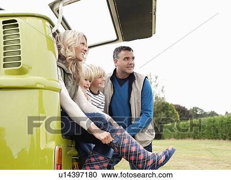 Stock Image - Family at back of camper van. Fotosearch