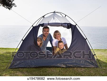 Stock Image - Family camping with tent by sea. Fotosearch
