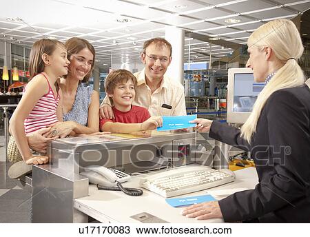 Family checking at the airport desk View Large Photo Image Stock Image - Family checking at the airport desk. Fotosearch