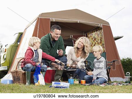 Family cooking together outdoors View Large Photo Image Picture - Family cooking together outdoors. Fotosearch