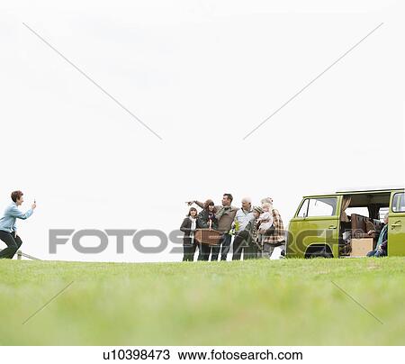 Family posing for picture near van View Large Photo Image Stock Image - Family posing for picture near van. Fotosearch