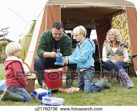 Family setting up camp View Large Photo Image Stock Photograph - Family setting up camp. Fotosearch