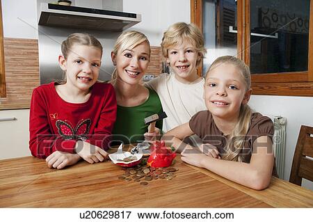 Family smash open a piggy bank View Large Photo Image Stock Photo - Family smash open a piggy bank. Fotosearch