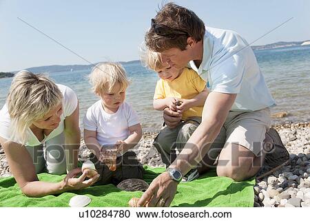 Family with twins at the beach View Large Photo Image Stock Image - Family with twins at the beach. Fotosearch
