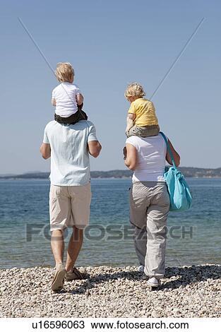 Family with twins at the beach View Large Photo Image Stock Image - Family with twins at the beach. Fotosearch