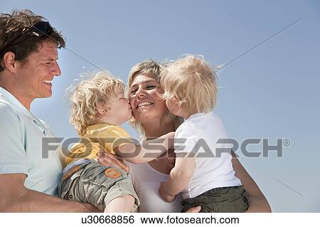 Family with twins kissing View Large Photo Image Stock Photograph - Family with twins kissing. Fotosearch
