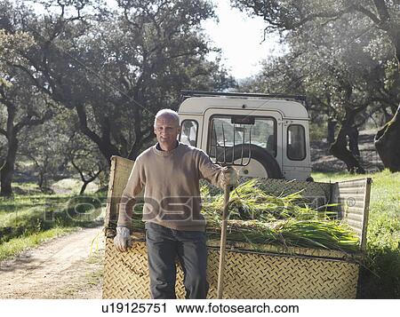 Farmer standing in front of trailer View Large Photo Image Stock Image - Farmer standing in front of trailer. Fotosearch