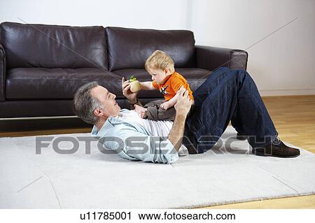 Father and baby playing on rug View Large Photo Image Stock Image - Father and baby playing on rug. Fotosearch