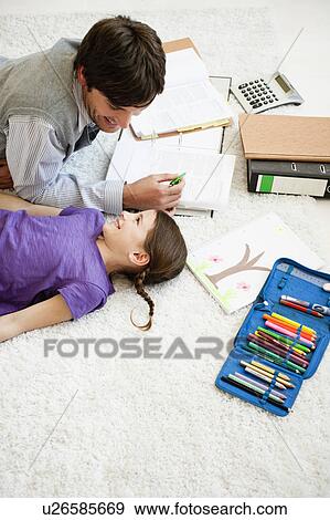 Stock Photo - Father and girl doing paperwork. Fotosearch