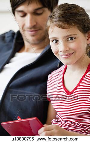 Stock Photography - Father and girl playing video game. Fotosearch