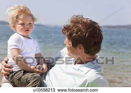 Stock Image - Father and son at the beach. Fotosearch