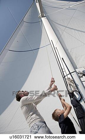 Father and son pulling rope on yacht View Large Photo Image Stock Image - Father and son pulling rope on yacht. Fotosearch