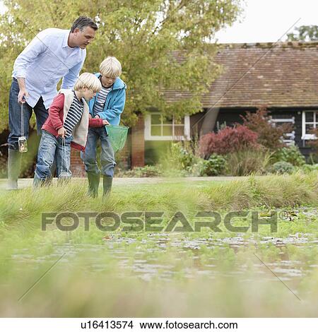 Father and sons by pond View Large Photo Image Picture - Father and sons by pond. Fotosearch