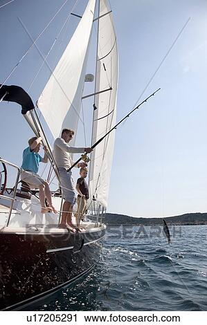 Father and sons fishing on yacht View Large Photo Image Stock Image - Father and sons fishing on yacht. Fotosearch