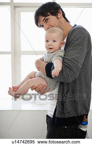 Stock Photography - Father holding baby boy. Fotosearch