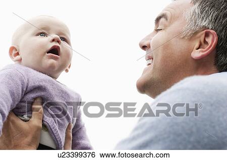 Father holding infant son View Large Photo Image Stock Photograph - Father holding infant son. Fotosearch