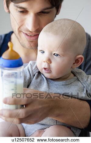 Father offering baby bottle View Large Photo Image Stock Image - Father offering baby bottle. Fotosearch