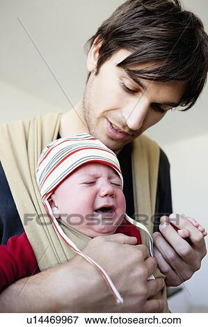 Stock Photo - Father soothing his baby. Fotosearch
