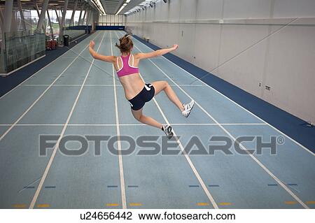 female athlete doing crazy star jump View Large Photo Image Stock Image - female athlete doing crazy star jump. Fotosearch