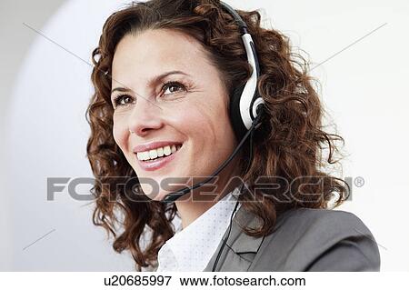 Stock Photo - female call center agent smiling. Fotosearch