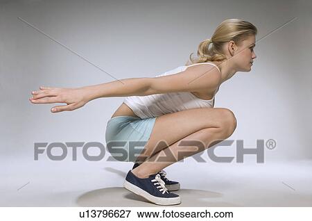 Female exercising in studio View Large Photo Image Stock Photo - Female exercising in studio. Fotosearch