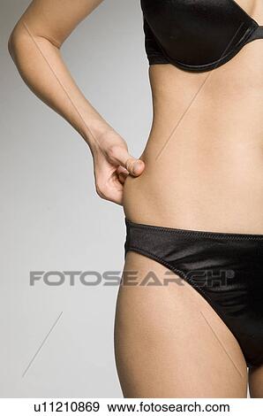 Female pinching fat on waist View Large Photo Image Stock Photo - Female pinching fat on waist. Fotosearch