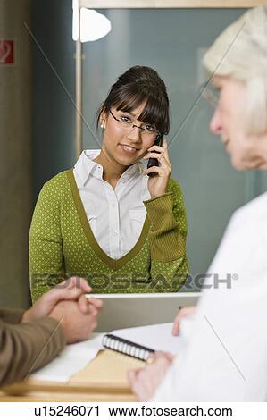 Stock Image - Female receptionist. Fotosearch