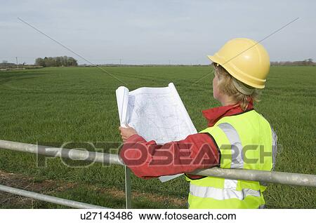 Stock Photograph - Female surveying countryside. Fotosearch