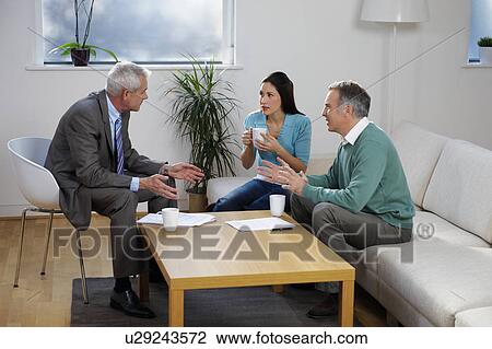 Financial adviser talking to couple View Large Photo Image Stock Image - Financial adviser talking to couple. Fotosearch
