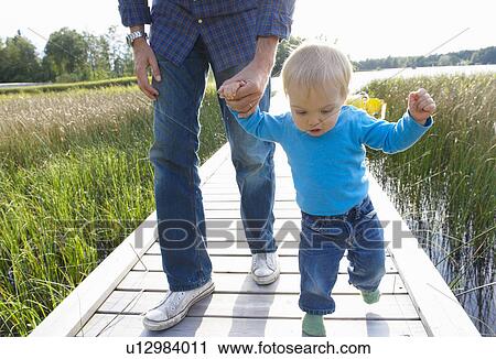 Firsts steps of a baby boy View Large Photo Image Stock Image - Firsts steps of a baby boy. Fotosearch
