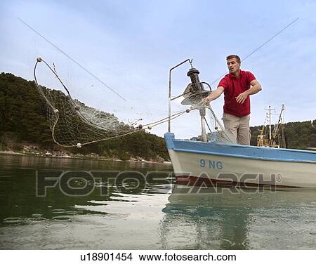 Picture - Fisherman fishing with net. Fotosearch