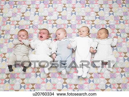Picture - Five babies on quilt. Fotosearch