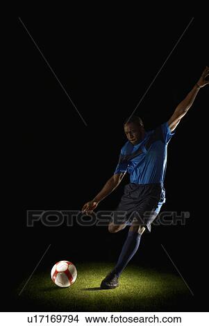 Picture - Football player about to kick ball. Fotosearch