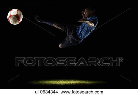 Picture - Footballer doing scissors kick. Fotosearch