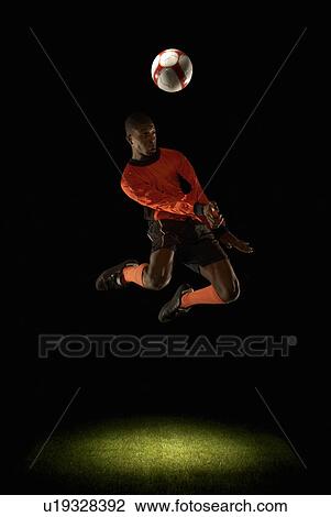 Footballer jumping for header View Large Photo Image Stock Image - Footballer jumping for header. Fotosearch