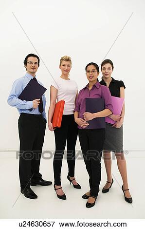 Four office workers look to camera View Large Photo Image Stock Photo - Four office workers look to camera. Fotosearch