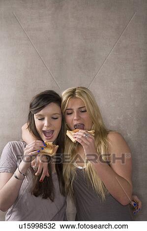 Friends eat sandwich together View Large Photo Image Stock Image - Friends eat sandwich together. Fotosearch
