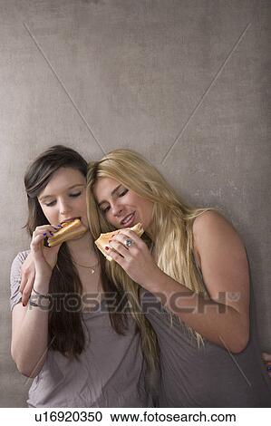 Stock Image - Friends eating sandwiches. Fotosearch