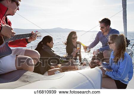 Friends with champagne on yacht View Large Photo Image Stock Photo - Friends with champagne on yacht. Fotosearch