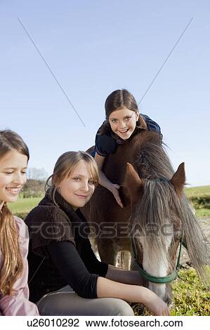 Stock Image - Friends with horse. Fotosearch