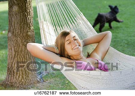 Girl and a dog in a garden View Large Photo Image Stock Photo - Girl and a dog in a garden. Fotosearch