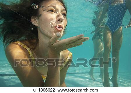 Girl blowing a kiss, underwater shot View Large Photo Image Stock Image - Girl blowing a kiss, underwater shot. Fotosearch