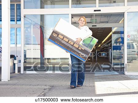 Girl carrying new-bought TV out of store View Large Photo Image Stock Image - Girl carrying new-bought TV out of store. Fotosearch