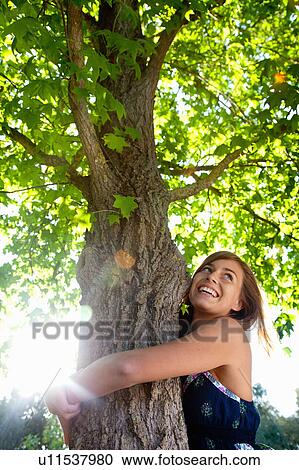 Girl hugging a tree View Large Photo Image Stock Image - Girl hugging a tree. Fotosearch