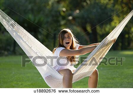 Girl in a hammock View Large Photo Image Stock Photograph - Girl in a hammock. Fotosearch
