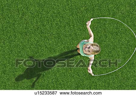 Girl jumping rope View Large Photo Image Stock Photo - Girl jumping rope. Fotosearch