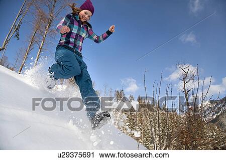 Girl jumping, running in snow View Large Photo Image Stock Image - Girl jumping, running in snow. Fotosearch
